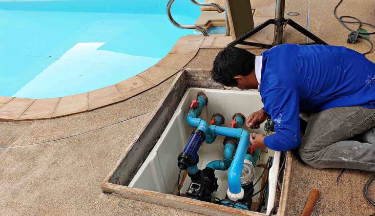 Pool Technician letting air out of swimming pool water pump.